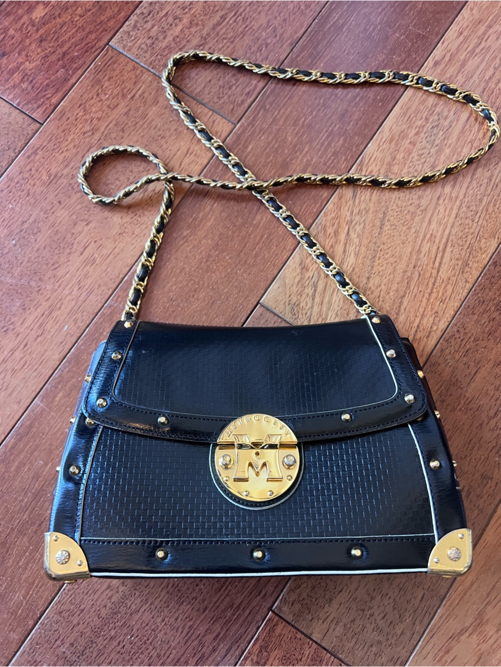 MetroCity Black Leather Crossbody with Gold Chain and Medallion Accent